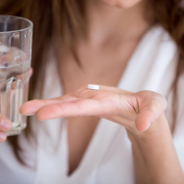 &lt;p&gt;Woman holding pill and glass of water in hands taking emergency medicine, supplements or antibiotic antidepressant painkiller medication to relieve pain, meds side effects concept, close up view&lt;/p&gt;