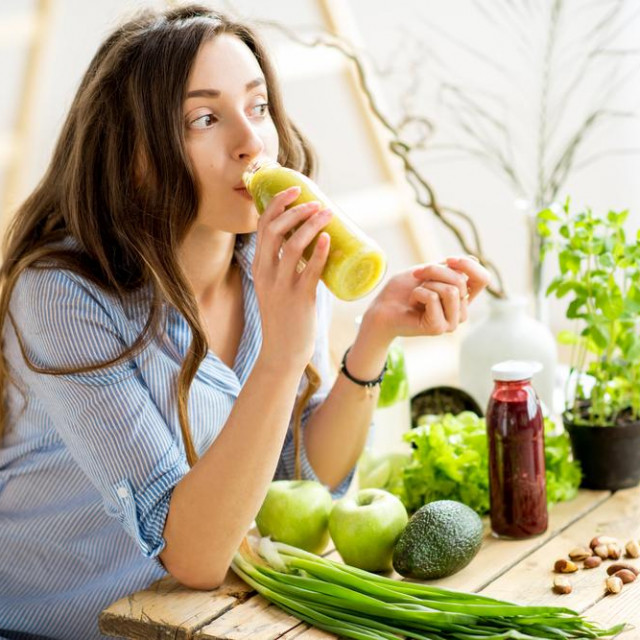&lt;p&gt;Beautiful woman sitting with healthy green food and drinking smoothie at home. Vegan meal and detox concept&lt;/p&gt;