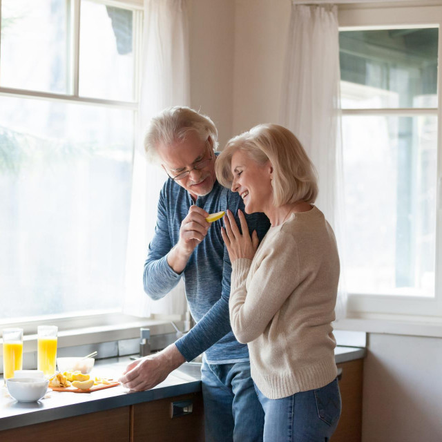 &lt;p&gt;Caring aged husband feed loving senior wife hugging him from behind, elderly romantic couple cook breakfast at home together, sensual man treat beloved woman embracing making food in kitchen&lt;/p&gt;