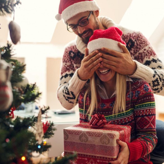 &lt;p&gt;Cropped shot of a man surprising his girlfriend with a Christmas gift.&lt;/p&gt;