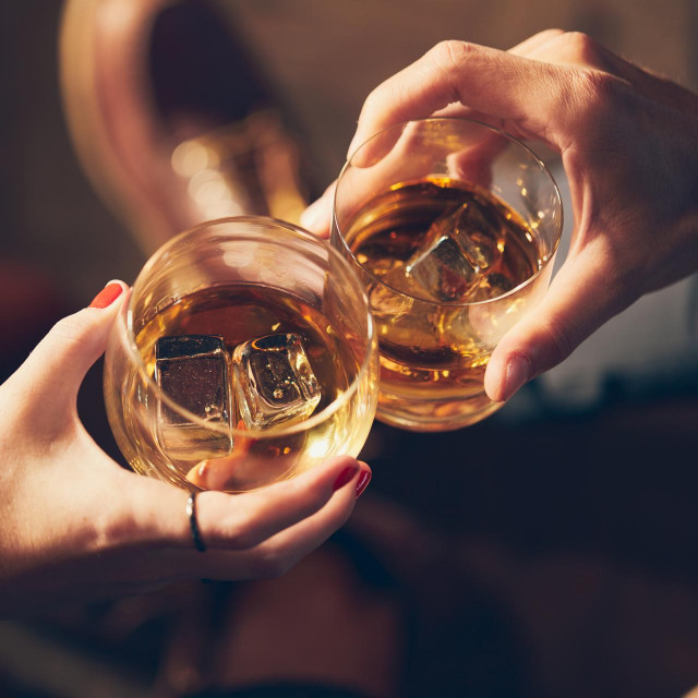 &lt;p&gt;A couple makes a toast with two glasses of whiskey&lt;/p&gt;