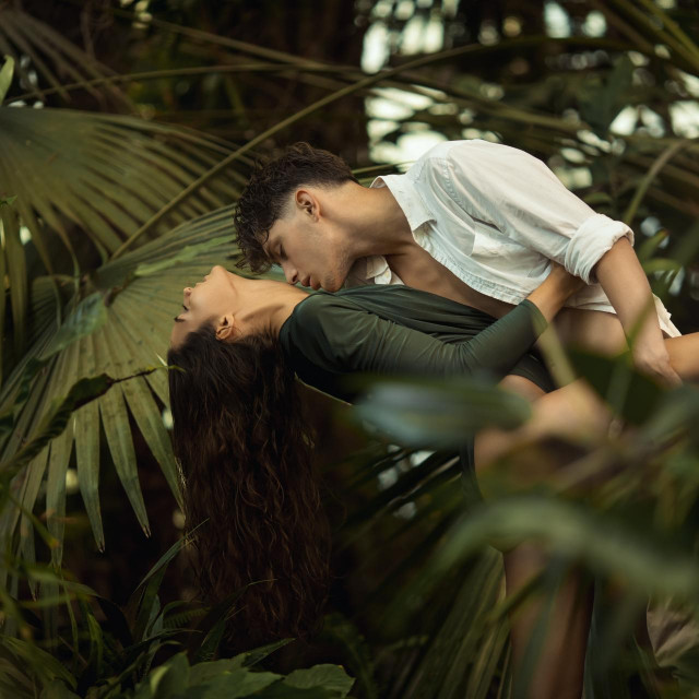 &lt;p&gt;Romantic couple in the tropical jungle among exotic plants. Young attractive slim girl and handsome man in love, embracing each other in a tropical forest. Tropical paradise for lovers&lt;/p&gt;