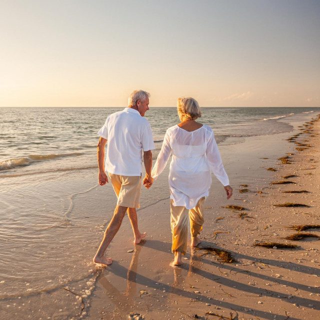 &lt;p&gt;Happy senior man and woman old retired couple walking and holding hands on a beach at sunset, s3niorlife&lt;/p&gt;