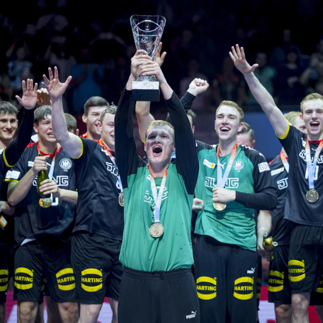 02 July 2023, Berlin: Handball: World Cup, U-21, Germany - Hungary, final round, final, Max-Schmeling-Halle Berlin, July 2, 2023. The final of the U21 Handball World Cup 2023 is won by the German national handball team (Germany, GER, black) against Hungary (HUN, white) and celebrates winning the World Cup. Goalkeeper David Sp?th raises the trophy to the cheers of his teammates. Photo: Sascha Klahn/dpa (Photo by Sascha Klahn/DPA/dpa Picture-Alliance via AFP)