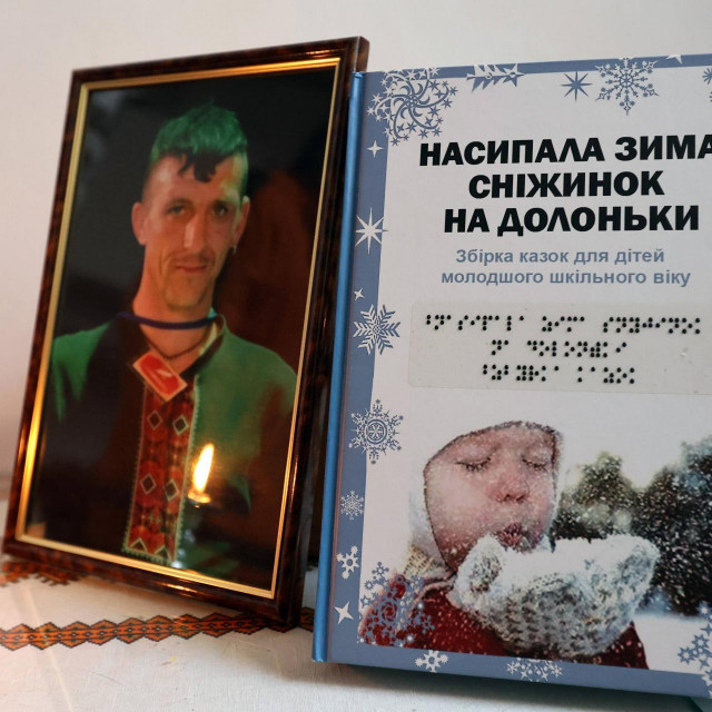 KHARKIV, UKRAINE - DECEMBER 6, 2022 - The portrait of Ukrainian children‘s author Volodymyr Vakulenko killed by Russian invaders during the temporary occupation of Kharkiv Region is pictured next to the writer‘s collection of fairy tales as the funeral ceremony takes place at the Saint Demetrius Church of the Ukrainian Greek Catholic Church, Kharkiv, northeastern Ukraine. Volodymyr Vakulenko, 49, was detained by Russian occupiers in his native Kapytolivka village, Izium district, in March 2022. The writer‘s body with two Makarov pistol bullets was found in the mass grave in liberated Izium, Kharkiv Region, under the number 319. In late November, his identity was confirmed with a DNA test. //UKRINFORMAGENCY_09300019/Credit:Alona_Nikolaievych/Ukrinf/SIPA/2212070952/Credit:Alona_Nikolaievych/Ukrinf/SIPA/2212071007,Image: 743042824, License: Rights-managed, Restrictions:, Model Release: no, Credit line: Alona_Nikolaievych/Ukrinf/Sipa Press/Profimedia
