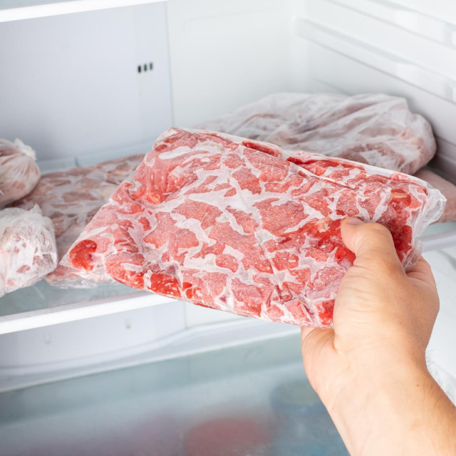 &lt;p&gt;The Man takes out a bag of frozen meat from the freezer in the kitchen at home. Frozen food&lt;/p&gt;