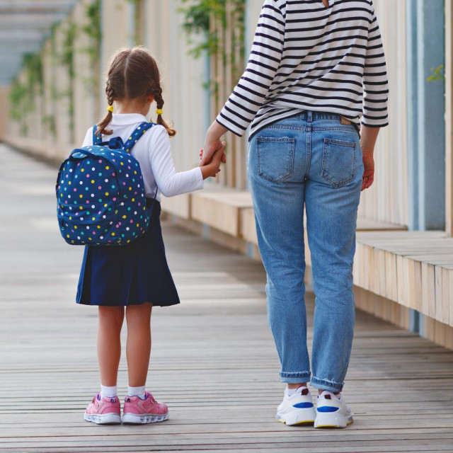 &lt;p&gt;first day at school. mother leads a little child school girl in first grade&lt;/p&gt;