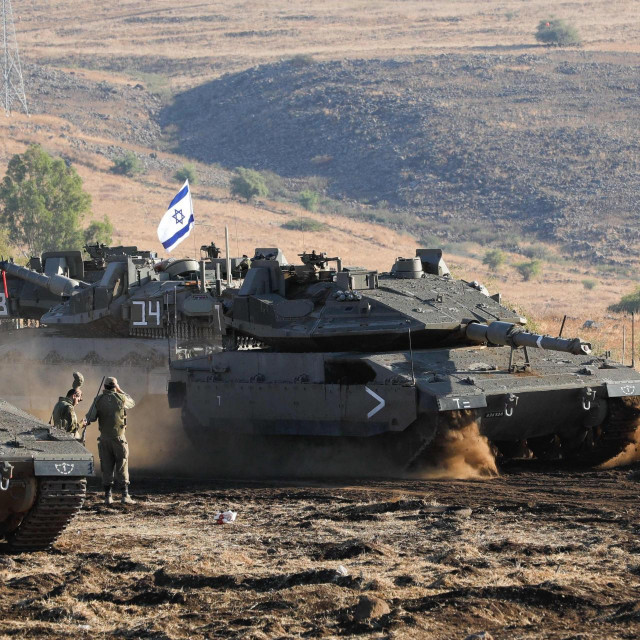 An Israeli Merkava tank drives into position in the north of Israel near the border with Lebanon on October 15, 2023. (Photo by Jalaa MAREY/AFP)