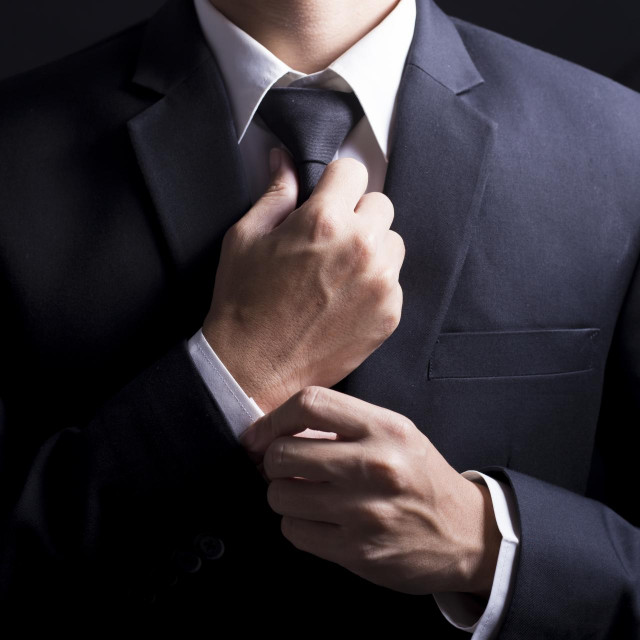 Businessman Adjust Necktie his Suit