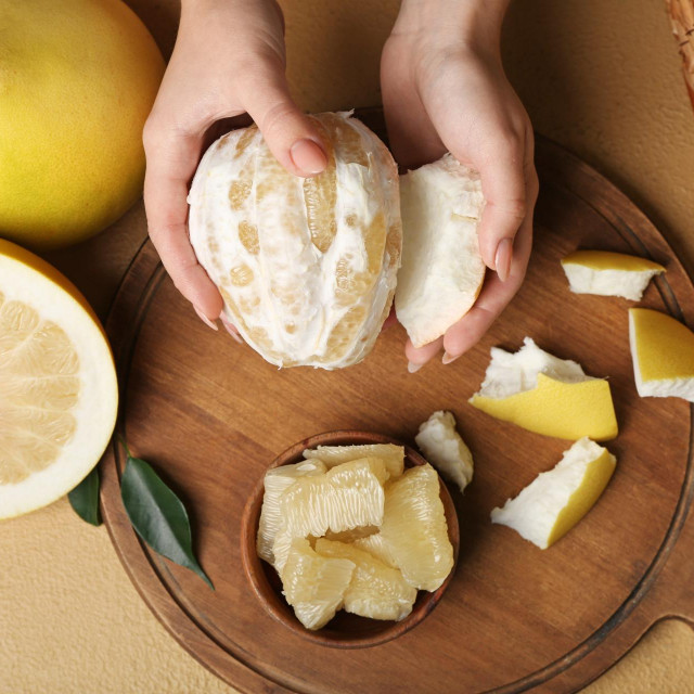 &lt;p&gt;Female hands with halves of sweet pomelo fruits on beige background&lt;/p&gt;