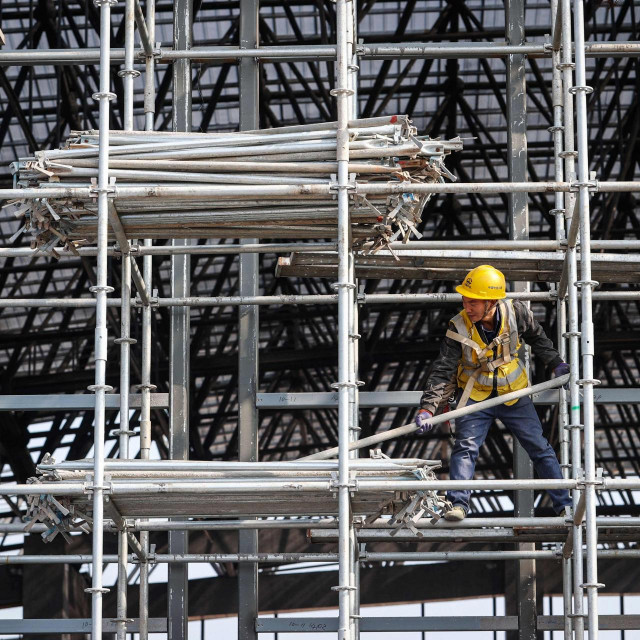 &lt;p&gt;Workers are seen on scaffolding at a railway station construction site in southwestern China‘s Chongqing municipality on February 18, 2024. (Photo by AFP)/China Out&lt;/p&gt;