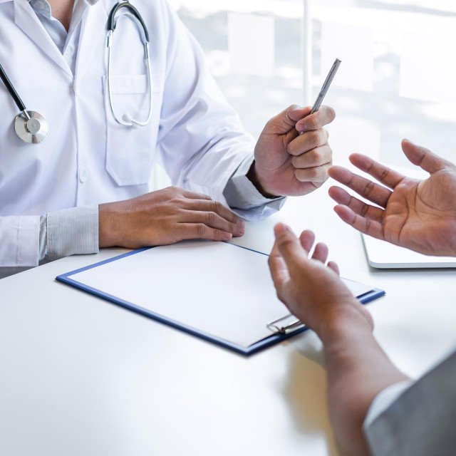 Doctor and patient are discussing consultation about symptom problem diagnosis of disease talk to the patient about medication and treatment method.