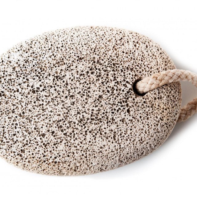 pumice foot shaped scrub tool isolated on white background