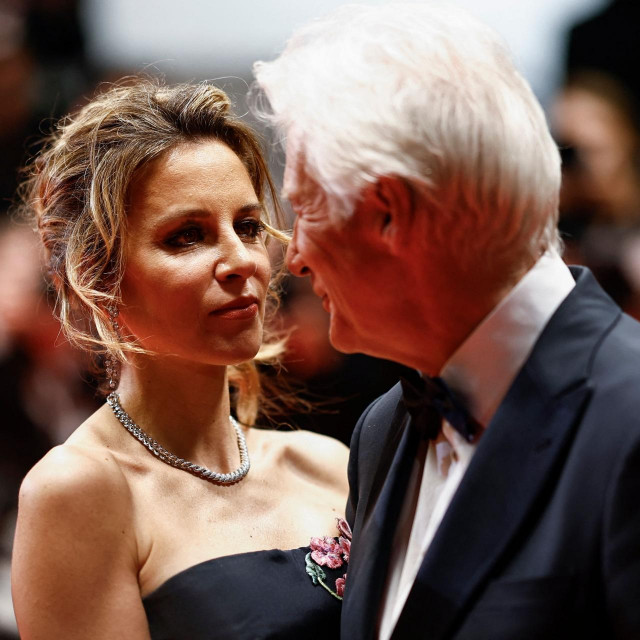 US actor Richard Gere (R) poses with his wife Spanish Alejandra Silva after the screening of the film ”Oh Canada” at the 77th edition of the Cannes Film Festival in Cannes, southern France, on May 18, 2024. (Photo by Sameer Al-Doumy/AFP)