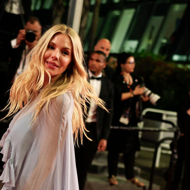 British-US actress Sienna Miller leaves after the screening of the film ”Horizon: An American Saga” at the 77th edition of the Cannes Film Festival in Cannes, southern France, on May 19, 2024. (Photo by Valery HACHE/AFP)