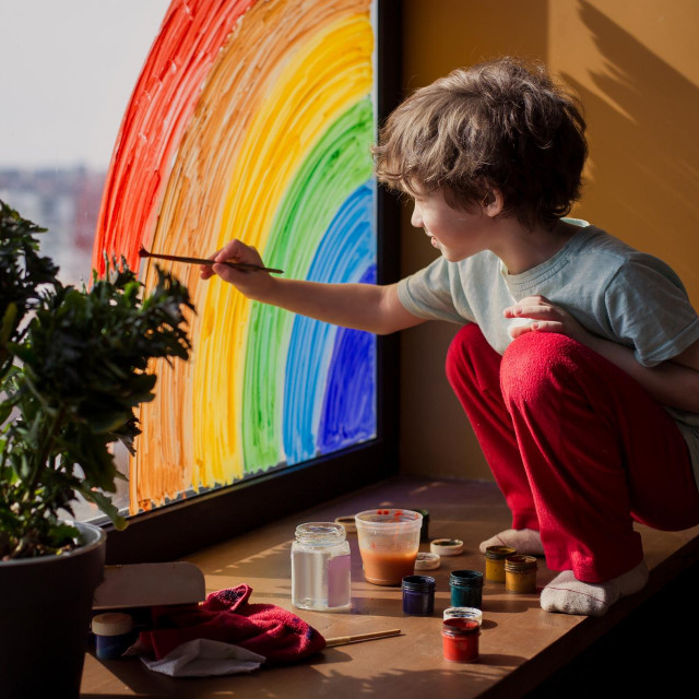 let‘s all be well. child at home draws a rainbow on the window. Flash mob society community on self-isolation quarantine pandemic coronavirus. Children create artist paints creativity vacation