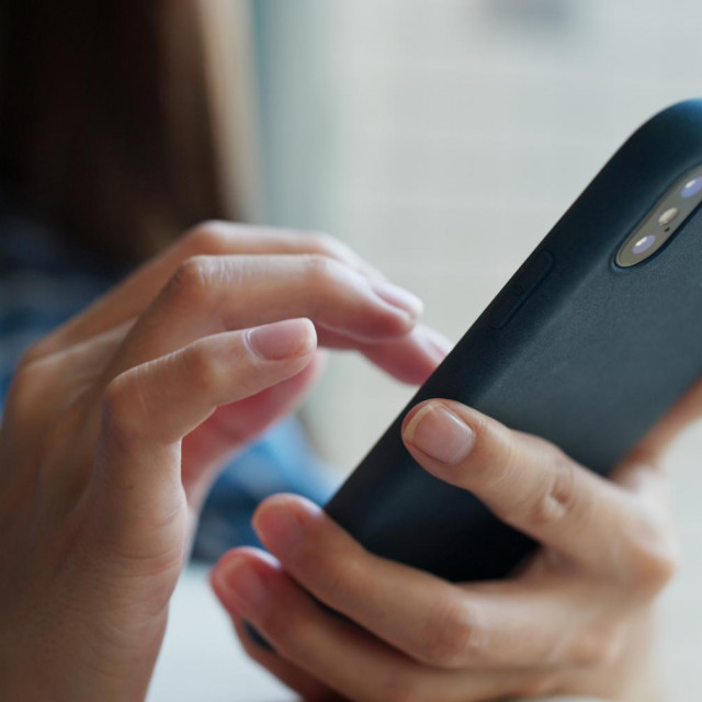 Woman use of mobile phone at home