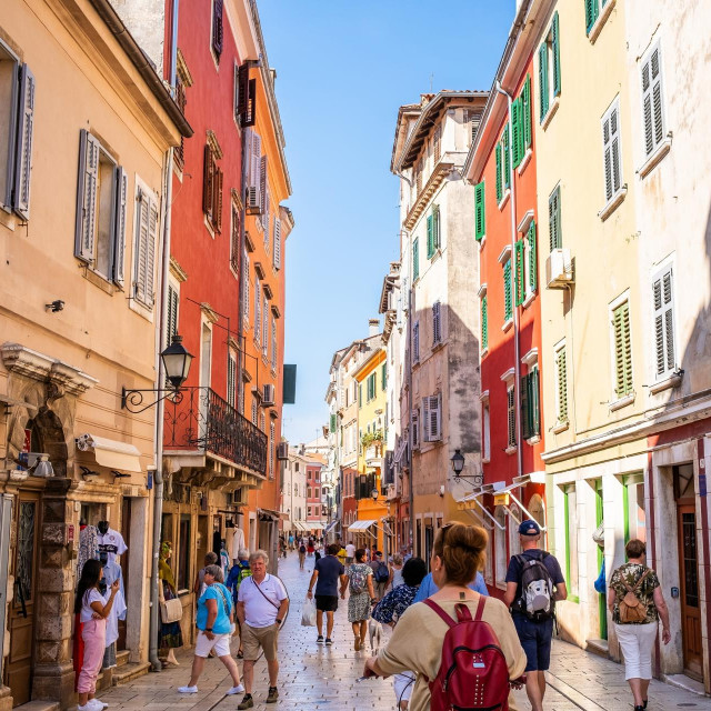 Rovinj, Croatia, September 30th, 2023A vibrant street in Rovinj Old Town lined with colorful buildings and bustling with tourists on a sunny day.