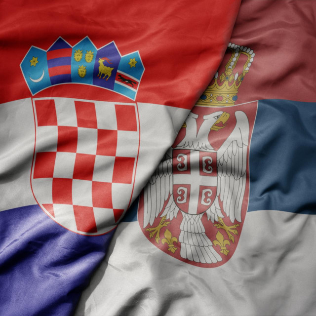 big waving national colorful flag of croatia and national flag of serbia. macro