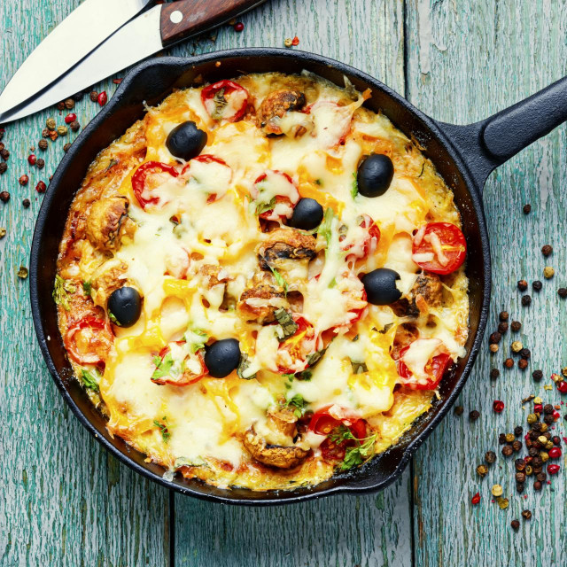 Appetizing Italian pizza with chicken breast, tomato,cheese and olives