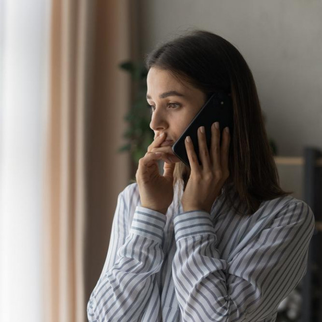 Sad millennial woman has difficult phone talk hold gadget by ear listen to unexpected bad news think on answer. Compassionate young lady support friend by cell try to help ponder on advice. Copy space