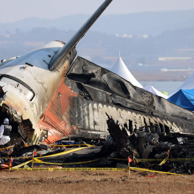 Officials from the Ministry of Land, Infrastructure and Transport‘s Aviation and Railway Accident Investigation Committee take part in the investigation at the site where a Jeju Air Boeing 737-800 aircraft crashed and burst into flames at Muan International Airport in Muan, some 288 kilometres southwest of Seoul on January 2, 2025. The Boeing 737-800 was carrying 181 people from Thailand to South Korea when it crashed on arrival on December 29, killing everyone aboard -- save two flight attendants pulled from the twisted wreckage of the worst aviation disaster on South Korean soil. (Photo by YONHAP/AFP)/- South Korea OUT/NO ARCHIVES - RESTRICTED TO SUBSCRIPTION USE