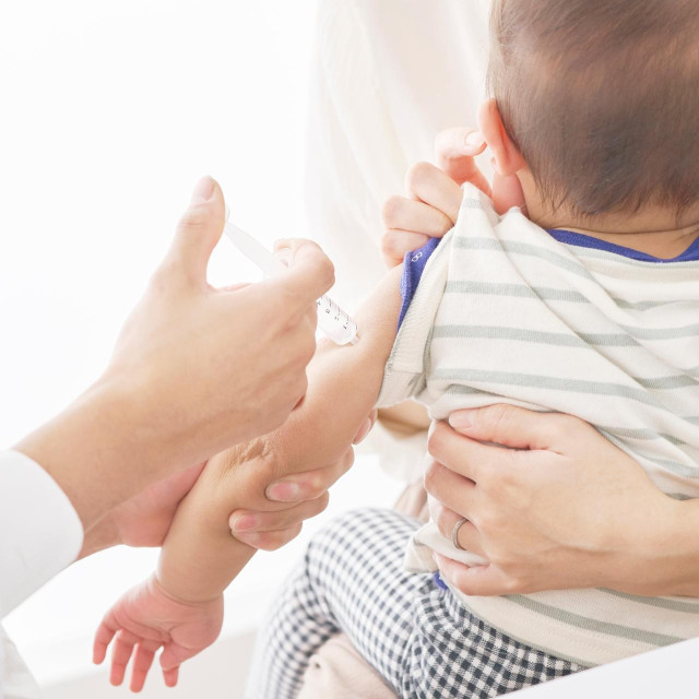 Asian baby being injected at the examining room