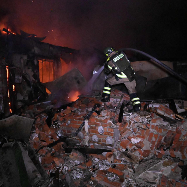 A Ukrainian firefighter works to extinguish afire in a building following a Russian drone strike in Kharkiv on April 29, 2025, amid the Russian invasion of Ukraine. (Photo by SERGEY BOBOK/AFP)